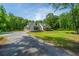 Beautiful two-story home with a well maintained lawn and gravel driveway at 1375 Tannanger Trl, Awendaw, SC 29429