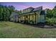 Inviting home exterior with a covered porch, wooden pillars, and a patriotic American flag at 1375 Tannanger Trl, Awendaw, SC 29429