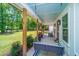 Relaxing front porch featuring a porch swing, seating area, and stylish decor creating a cozy outdoor space at 1375 Tannanger Trl, Awendaw, SC 29429