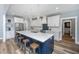 Modern kitchen with white cabinets, stainless steel appliances, and a large island with bar seating at 1375 Tannanger Trl, Awendaw, SC 29429