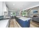 Spacious kitchen with stainless steel appliances, a blue island, and an open view to the dining and living areas at 1375 Tannanger Trl, Awendaw, SC 29429