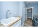 A well-lit laundry room featuring wood countertops, white cabinets, modern appliances, and light blue walls at 1375 Tannanger Trl, Awendaw, SC 29429