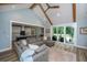 Comfortable living room featuring a large sectional sofa, sliding glass doors, and an open kitchen concept at 1375 Tannanger Trl, Awendaw, SC 29429