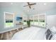 Bedroom featuring a TV, wood floors, a bed, and natural light from several windows at 1375 Tannanger Trl, Awendaw, SC 29429