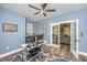 Home office with blue walls, a ceiling fan, and glass paneled french doors leading to living room at 1375 Tannanger Trl, Awendaw, SC 29429