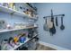 Walk-in pantry featuring shelving, storage containers, food items, and hanging metal cooking equipment at 1375 Tannanger Trl, Awendaw, SC 29429
