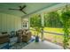 Screened-in porch with stylish furniture, ceiling fan, and an expansive backyard view at 1375 Tannanger Trl, Awendaw, SC 29429