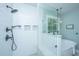 Bright glass enclosed shower with tiled walls and overhead shower head, situated next to a free standing tub at 1375 Tannanger Trl, Awendaw, SC 29429