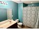 Bathroom features a double vanity sink, decorative shower curtain, and tiled flooring at 1401 Dabbling Duck Dr, Summerville, SC 29483