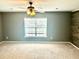 Bedroom showcasing a statement wood wall, a ceiling fan, and a window with neutral paint at 1401 Dabbling Duck Dr, Summerville, SC 29483
