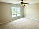 Bedroom featuring neutral walls, plush carpeting, a bright window, and a modern ceiling fan at 1401 Dabbling Duck Dr, Summerville, SC 29483
