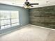 Bedroom showcasing a statement wood wall, a ceiling fan, and a window with neutral paint at 1401 Dabbling Duck Dr, Summerville, SC 29483