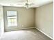 Cozy bedroom featuring carpet flooring, neutral walls, and a bright window at 1401 Dabbling Duck Dr, Summerville, SC 29483