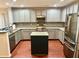 Beautiful updated kitchen featuring stainless steel appliances, a center island, modern gray cabinets, and hardwood floors at 1401 Dabbling Duck Dr, Summerville, SC 29483