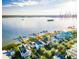 Breathtaking aerial view of a waterfront property with private docks, pristine beach, and lush landscaping at 1410 Smythe St, Charleston, SC 29492