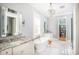 Bright bathroom featuring a freestanding tub, double vanity, and elegant chandelier at 1410 Smythe St, Charleston, SC 29492