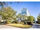 Charming light blue two-story home featuring manicured landscaping and a welcoming front porch at 1410 Smythe St, Charleston, SC 29492
