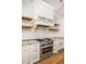Modern kitchen featuring white cabinetry, stainless steel appliances, and granite countertops at 1410 Smythe St, Charleston, SC 29492
