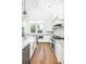Bright white kitchen featuring stainless appliances, granite countertops, and an island sink at 1410 Smythe St, Charleston, SC 29492