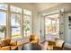 Cozy waterfront living room with leather chairs and natural light at 1410 Smythe St, Charleston, SC 29492