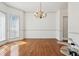 Spacious formal dining area with hardwood floors, chandelier, and bright windows at 143 Belleplaine Dr, Goose Creek, SC 29445