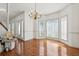Bright dining area boasts hardwood floors, a chair lift, a chandelier and walls of large sunny windows at 143 Belleplaine Dr, Goose Creek, SC 29445