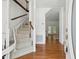 Bright foyer features hardwood floors, a winding staircase, and views into the adjacent rooms at 143 Belleplaine Dr, Goose Creek, SC 29445
