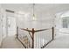 An upstairs hallway with neutral carpet, white walls and a pendant light fixture at 143 Belleplaine Dr, Goose Creek, SC 29445