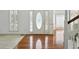 Airy living room with pristine white walls, hardwood floors, and natural light streaming through the windows at 143 Belleplaine Dr, Goose Creek, SC 29445