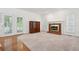 Cozy living room features a brick fireplace, built-in shelving, and french doors to the outside at 143 Belleplaine Dr, Goose Creek, SC 29445