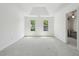 Bright main bedroom featuring carpet floors and two windows at 143 Belleplaine Dr, Goose Creek, SC 29445