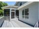 A wooden porch with grey-painted planks and white railings provides an outdoor living space attached to the house at 143 Belleplaine Dr, Goose Creek, SC 29445