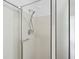 A tiled shower with a glass door and an adjustable shower head, offering a clean and modern design at 143 Belleplaine Dr, Goose Creek, SC 29445