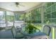 Relaxing sunroom featuring large windows, wicker furniture, and ceiling fan providing a serene and bright space at 143 Belleplaine Dr, Goose Creek, SC 29445