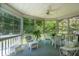 Relaxing screened-in porch featuring a ceiling fan and wicker furniture at 143 Belleplaine Dr, Goose Creek, SC 29445