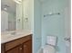 Bright bathroom features teal colored walls, a dark wood vanity, toilet and a mirror at 1533 Bluewater Way, Charleston, SC 29414