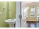 Bathroom with a pedestal sink and green painted walls at 1533 Bluewater Way, Charleston, SC 29414
