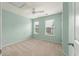 Comfortable bedroom includes soft carpet flooring, a ceiling fan, and two large windows that bring in natural light at 1533 Bluewater Way, Charleston, SC 29414
