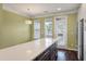 Sunlit dining area featuring wood floors, a modern light fixture, and large windows at 1533 Bluewater Way, Charleston, SC 29414