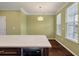 Light-filled dining area with wood floors, modern lighting, and large windows at 1533 Bluewater Way, Charleston, SC 29414