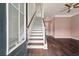 Inviting foyer with hardwood floors, a grand staircase, and a view of the adjacent living area at 1533 Bluewater Way, Charleston, SC 29414