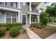 Inviting front door with well-maintained landscaping and mulched flower beds and covered porch at 1533 Bluewater Way, Charleston, SC 29414