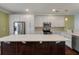 Bright kitchen with white cabinetry, stainless appliances, and a large island with stone countertop at 1533 Bluewater Way, Charleston, SC 29414