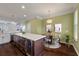 Eat-in kitchen featuring a quartz island with wine fridge, pendant lighting, and a dining table at 1533 Bluewater Way, Charleston, SC 29414