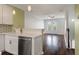 Stylish kitchen with stainless steel dishwasher, white cabinets, and seamless access to the living space at 1533 Bluewater Way, Charleston, SC 29414