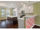 Modern kitchen featuring stainless steel appliances, white cabinets, and a large island at 1533 Bluewater Way, Charleston, SC 29414