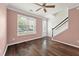 Bright living room featuring wood floors, white trim, neutral paint, and a staircase at 1533 Bluewater Way, Charleston, SC 29414