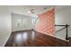 Open living room with hardwood floors, decorative wallpaper, and a staircase at 1533 Bluewater Way, Charleston, SC 29414