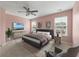 Serene main bedroom with carpet flooring, a ceiling fan, two windows, and decor at 1533 Bluewater Way, Charleston, SC 29414