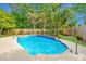 Backyard showcasing a swimming pool with palms, mature trees, and lush green lawn at 1582 Ocean Neighbors Blvd, Charleston, SC 29412